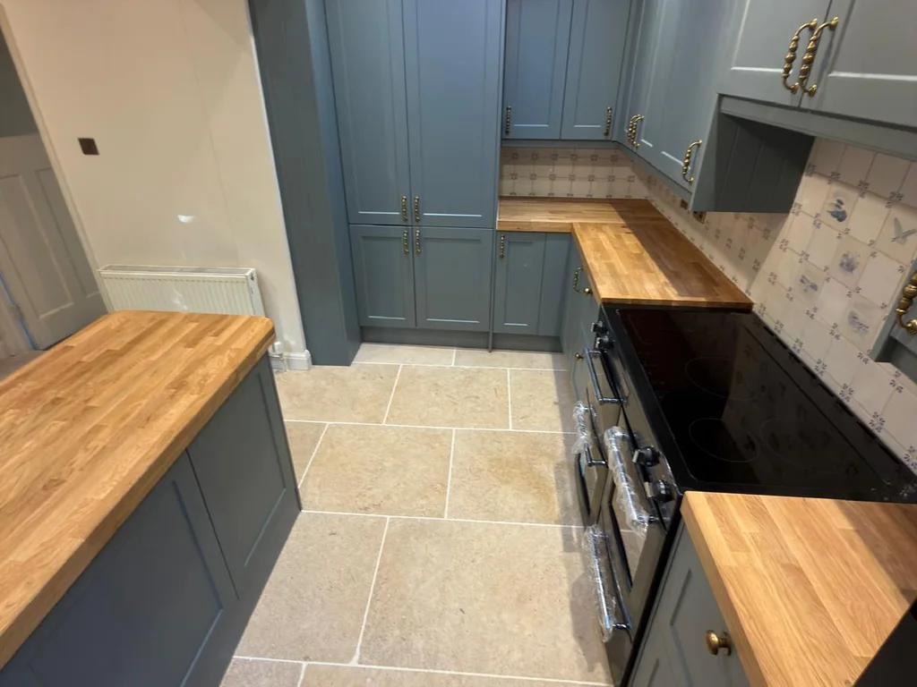 A teal shaker kitchen with oak worktops and a roof light from our project gallery